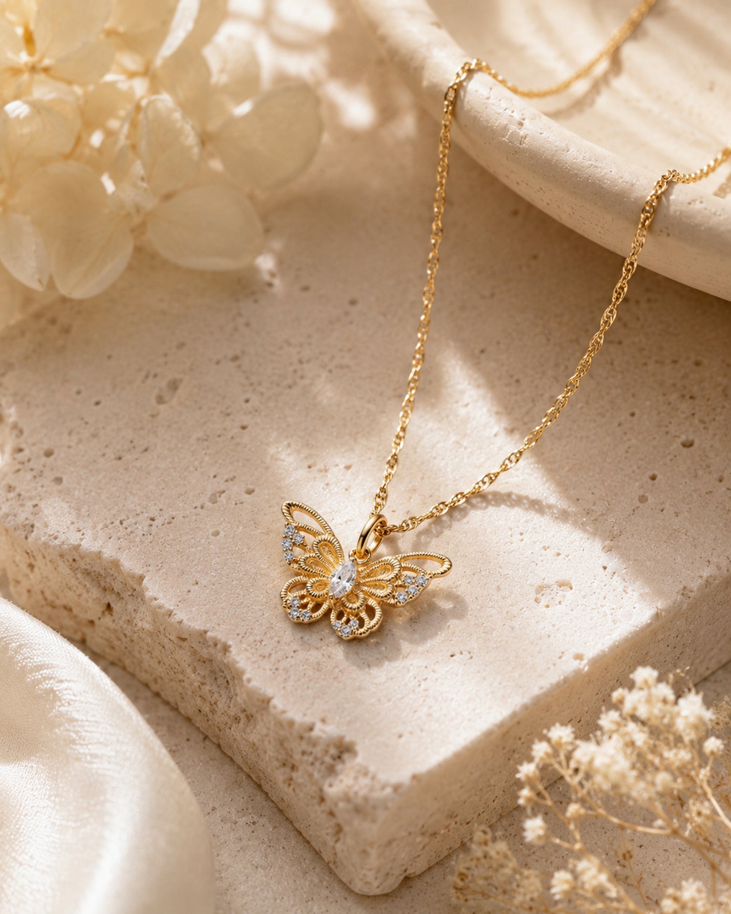 Theiaura Gilded Butterfly Pendant Necklace in a warm neutral lifestyle setting