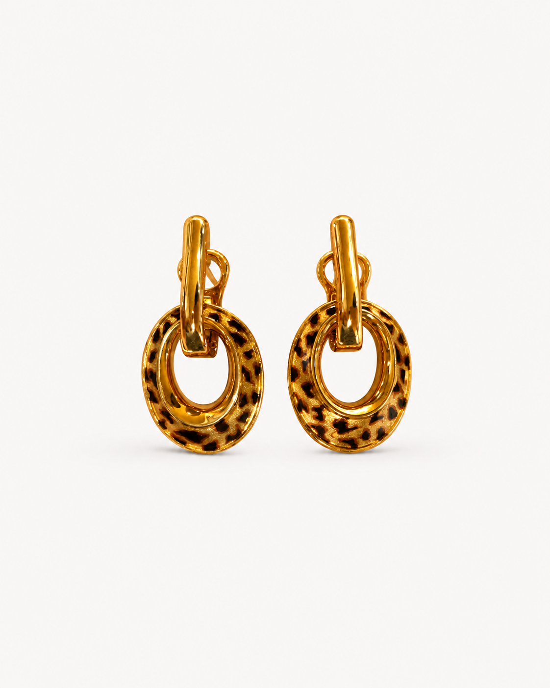 A pair of Theiaura Leopard Loop Hoop Earrings on a clean off-white background