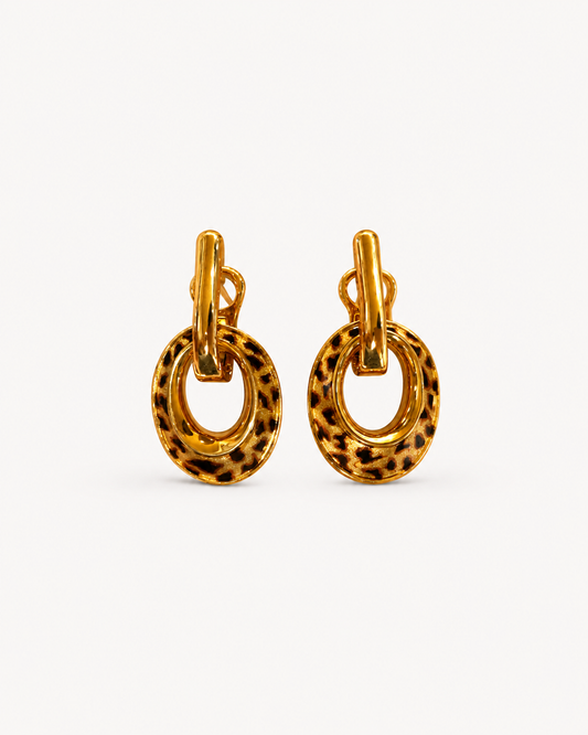 A pair of Theiaura Leopard Loop Hoop Earrings on a clean off-white background