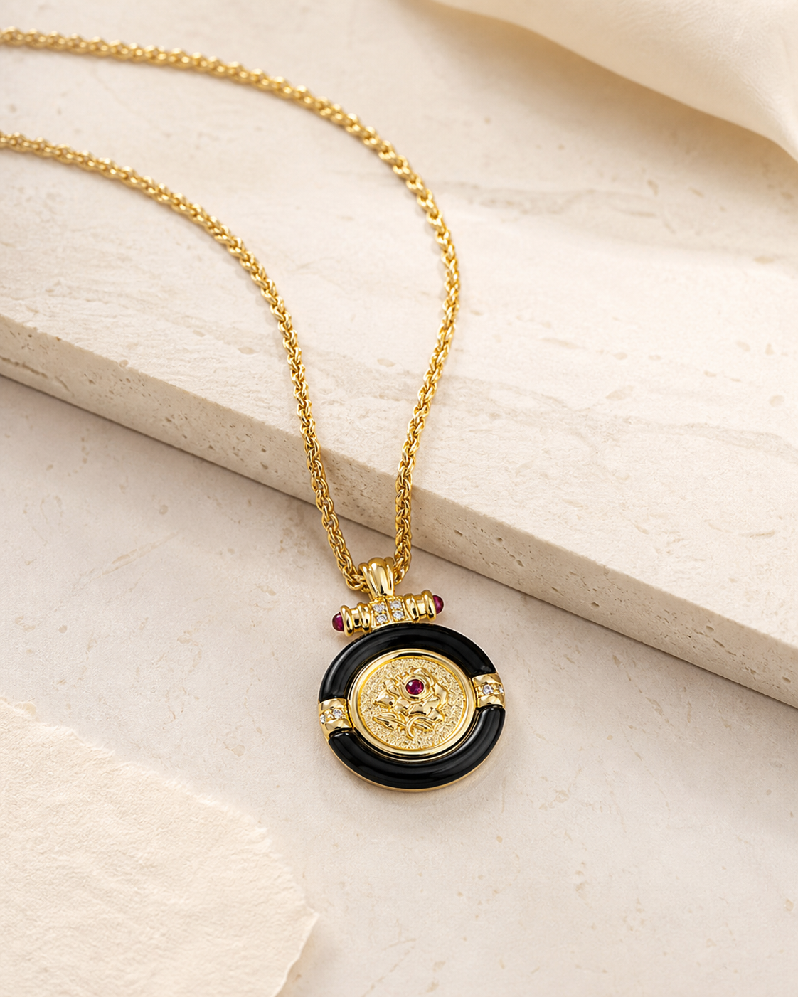 Theiaura Rosalia Medallion Pendant Necklace styled on warm ivory stone